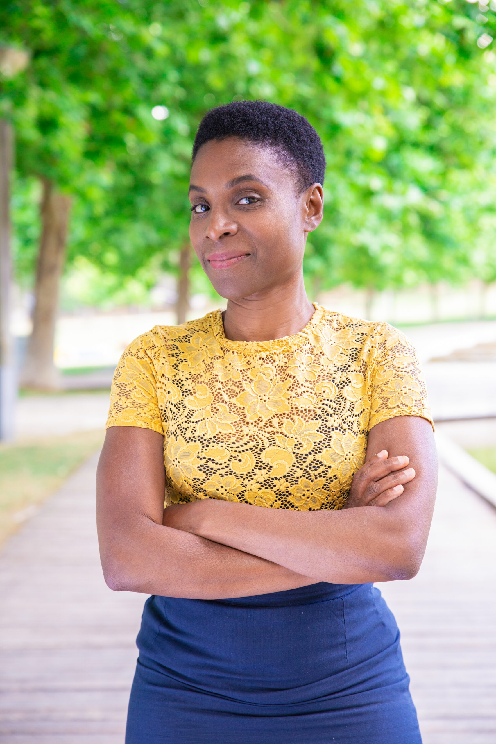 content attractive black with keeping arms crossed outdoors