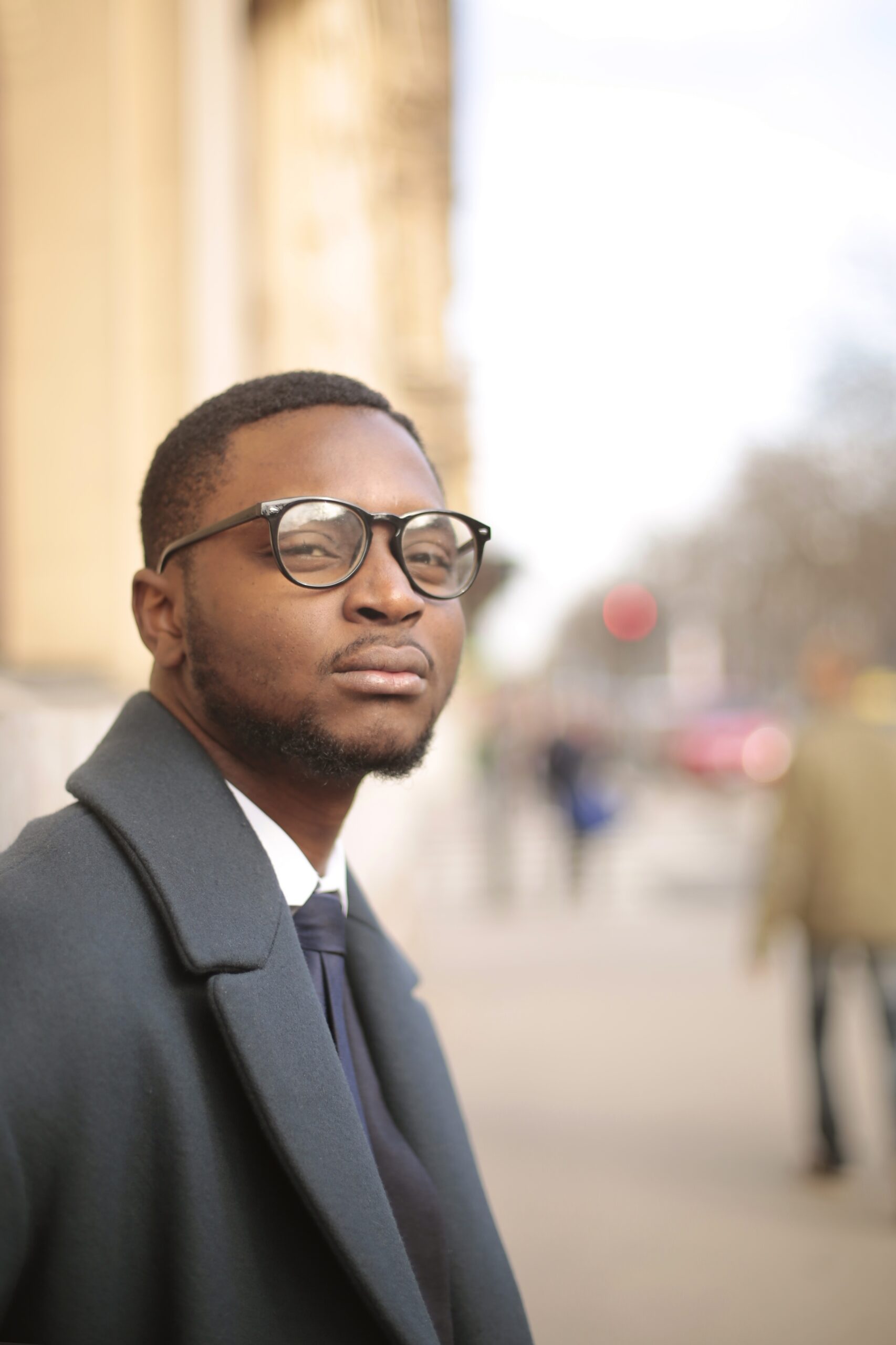 vertical shot of a well dressed african american male looking at the camera